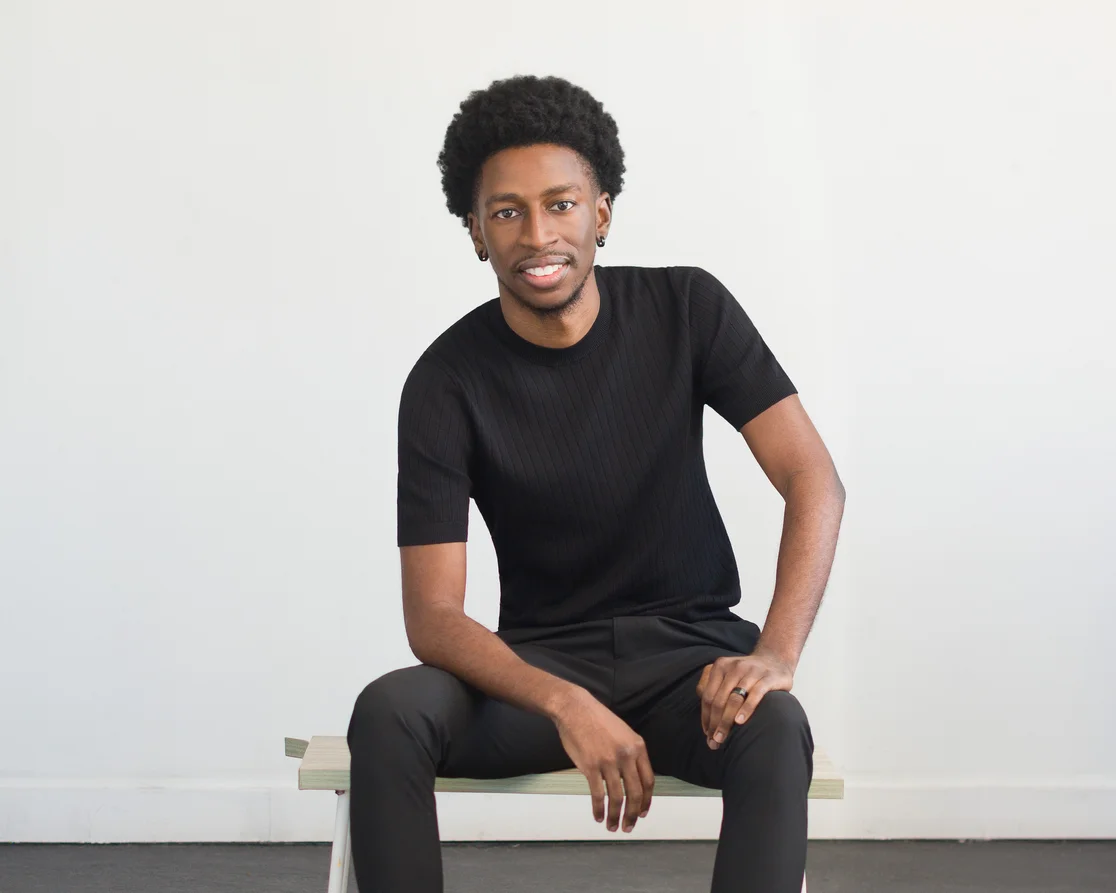 Karim smiling, wearing a black shirt.